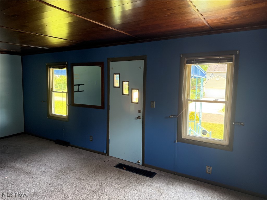 6350 Meadowbrook Road Garfield Heights, OH 44125 - Photo 18 of 28 Empty room with wood ceiling, carpet flooring, and healthy amount of natural light
