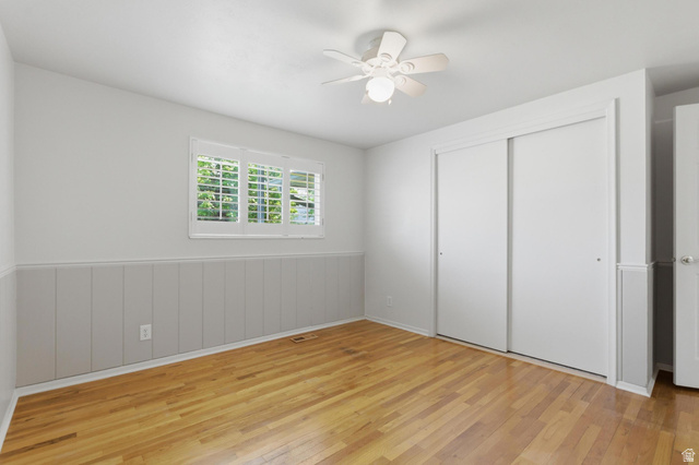 148 Tennyson Avenue Sandy, UT 84070 - Photo 24 of 55 Interior room featuring wood-finish flooring, white paneled wainscoting, and white wall paint