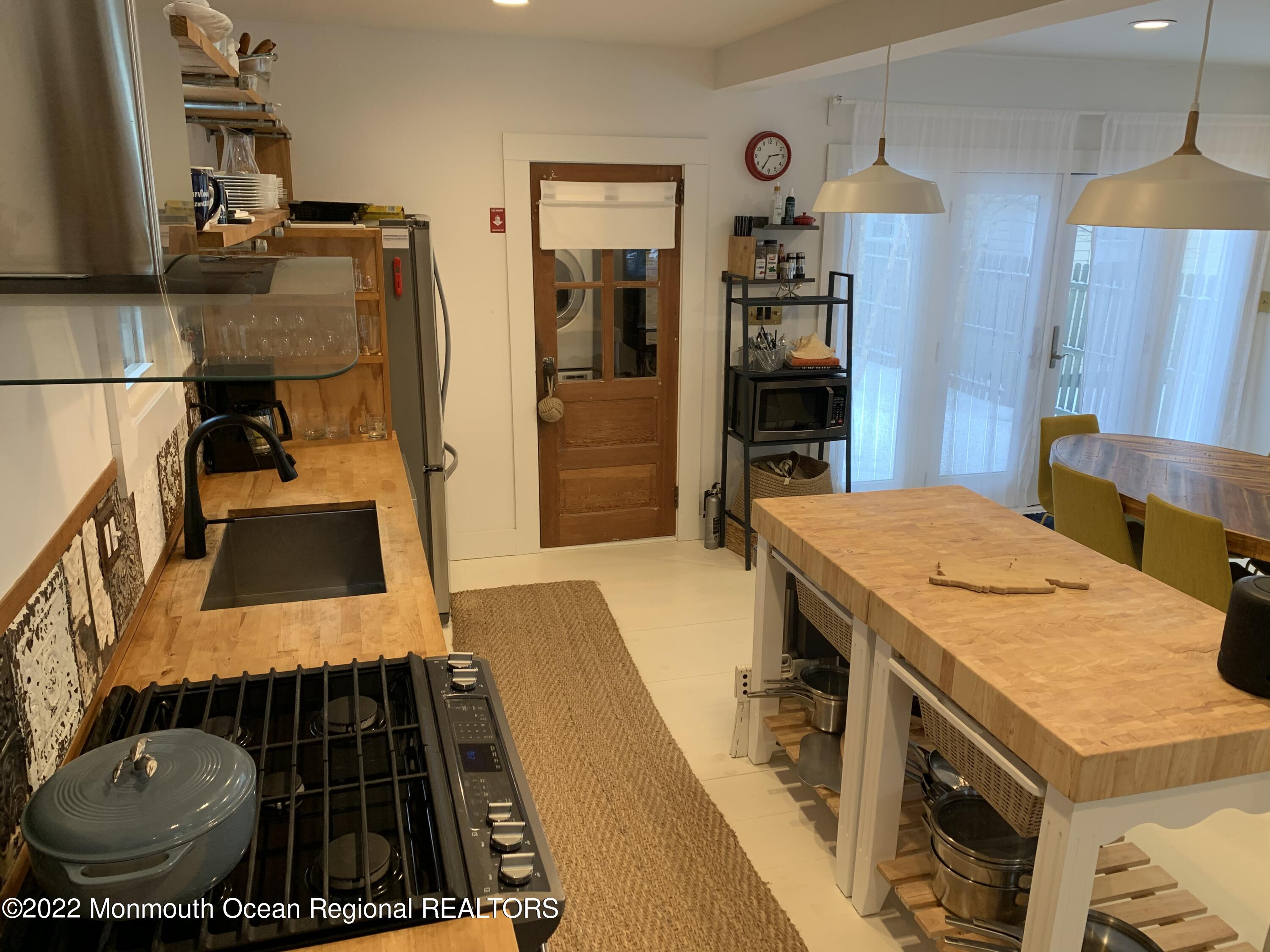 a kitchen with sink stove and refrigerator
