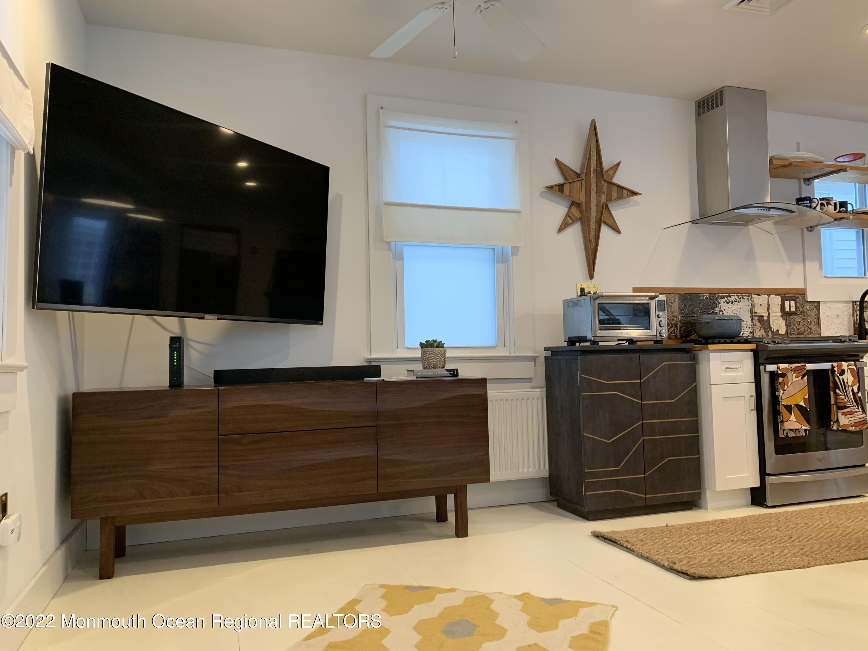 1836 Parkway Lake Como, NJ 07719 - Photo 11 of 32 a living room with furniture and a flat screen tv