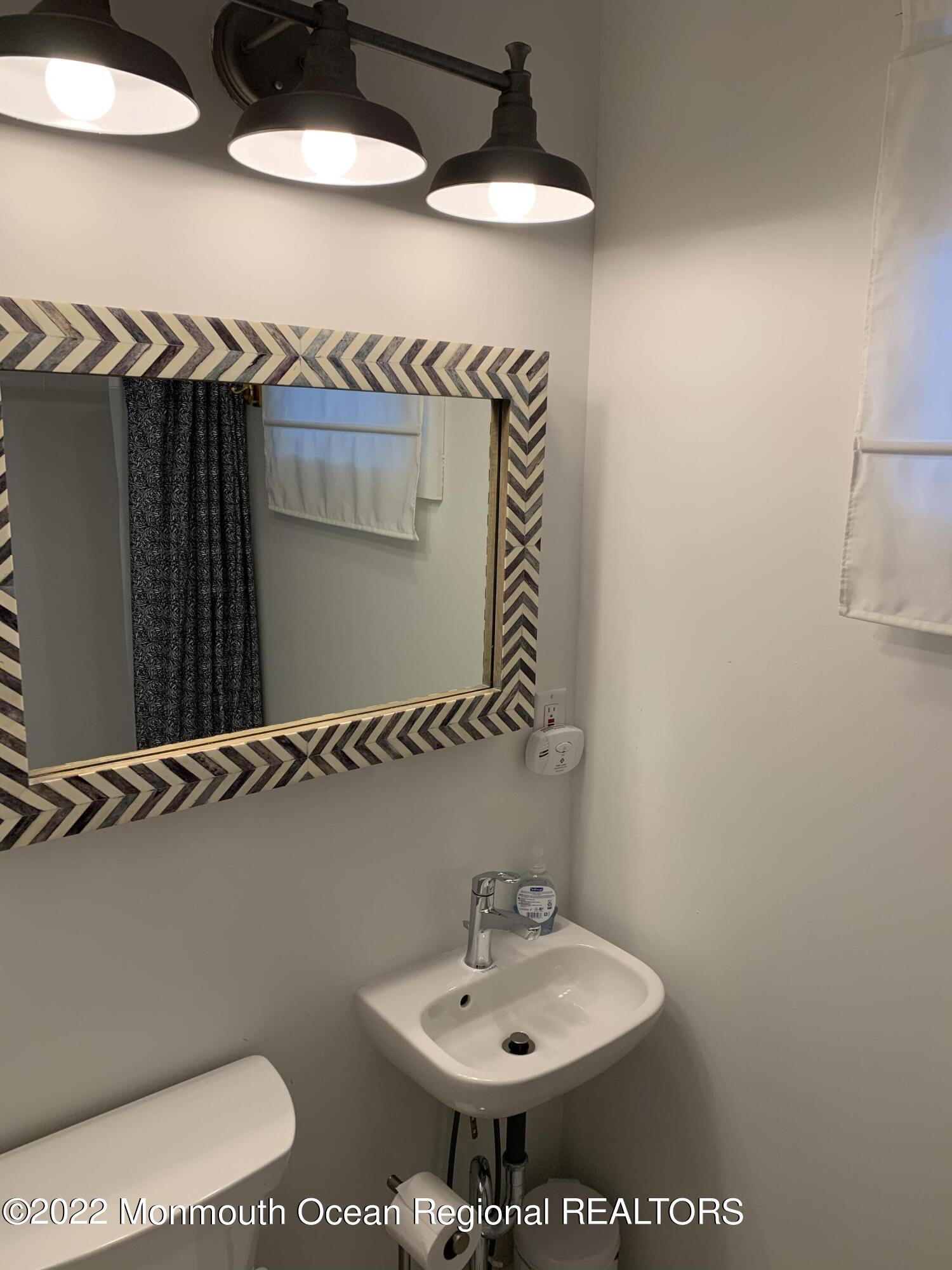 1836 Parkway Belmar, NJ 07719 - Photo 13 of 32 a bathroom with a sink and a mirror