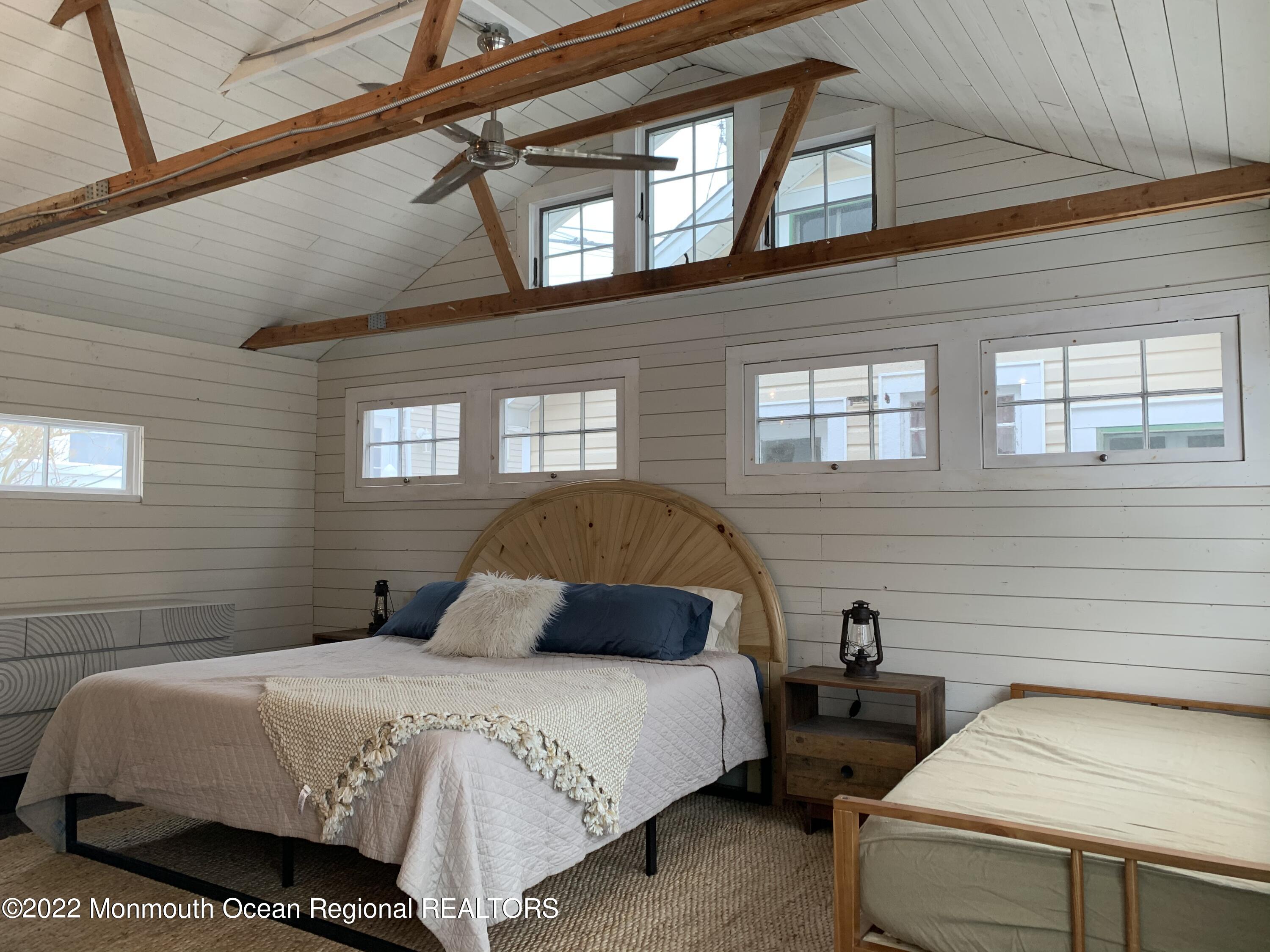 1836 Parkway Belmar, NJ 07719 - Photo 27 of 32 a bedroom with a bed and a dresser next to a window