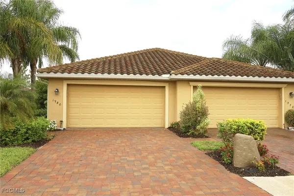 a view of a house with a yard and plants