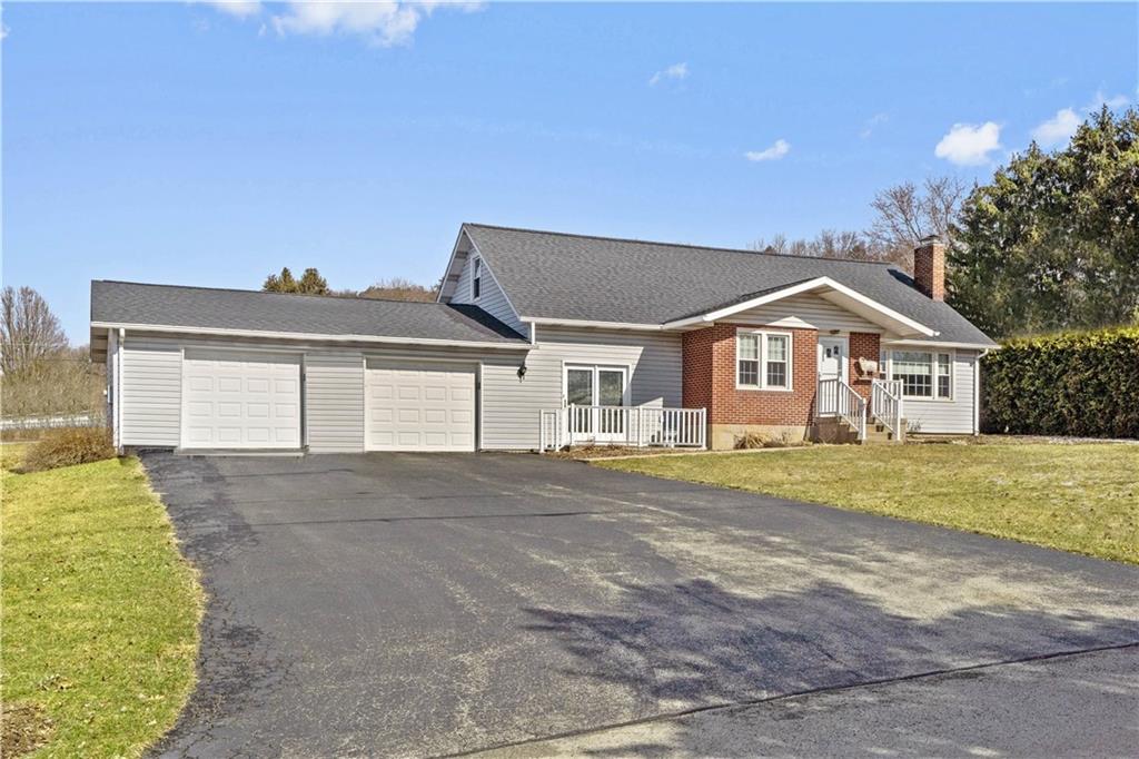 2490 Home Street Indiana, PA 15701 - Photo 1 of 22 a front view of a house with a yard and garage