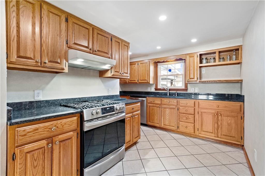 2490 Home Street Indiana, PA 15701 - Photo 6 of 22 a kitchen with stainless steel appliances granite countertop a stove sink and cabinets
