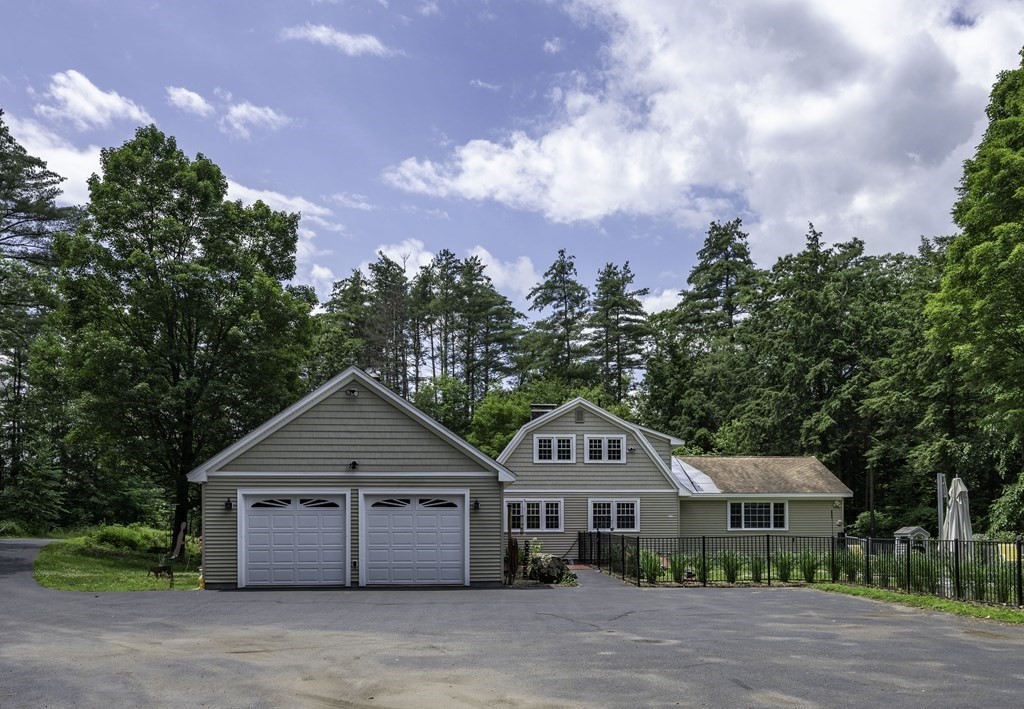12 West Gill Road Gill, MA 01354 - Photo 1 of 42 a front view of a house with a garden
