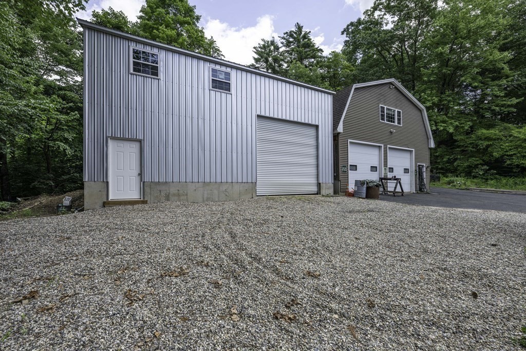 12 West Gill Road Gill, MA 01354 - Photo 12 of 42 a front view of a house with a yard and garage