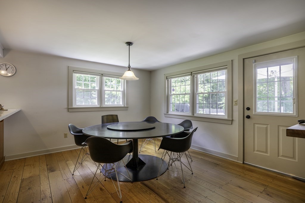 12 West Gill Road Gill, MA 01354 - Photo 18 of 42 a dining room with furniture a chandelier and wooden floor