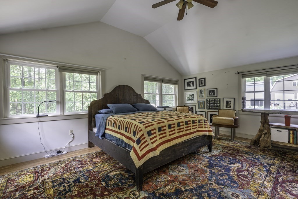 12 West Gill Road Gill, MA 01354 - Photo 27 of 42 a bedroom with a bed a table and windows
