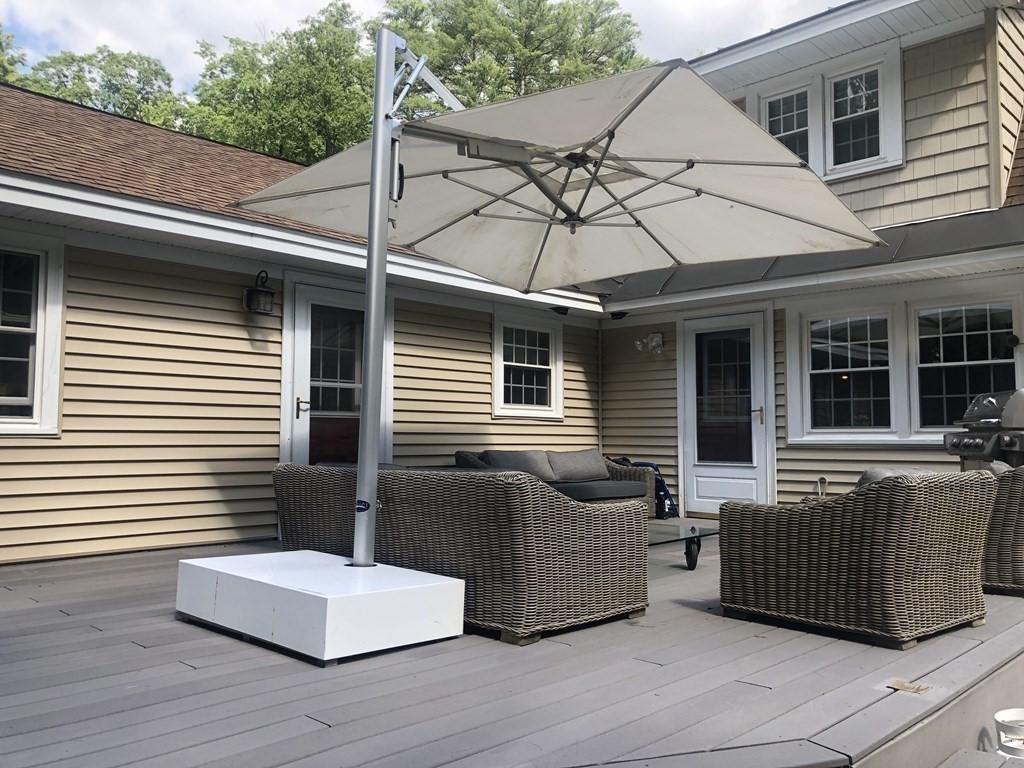 12 West Gill Road Gill, MA 01354 - Photo 36 of 42 a view of a patio with couches chairs and wooden floor