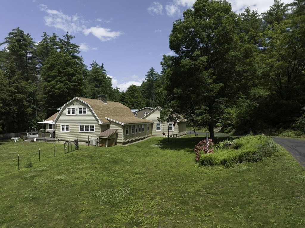 12 West Gill Road Gill, MA 01354 - Photo 6 of 42 a large house with a big yard and large trees