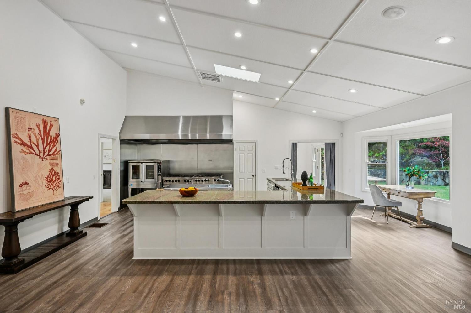 5 Maoli Drive San Rafael, CA 94903 - Photo 13 of 74 a view of a kitchen with kitchen island a large counter space a sink appliances and a large window