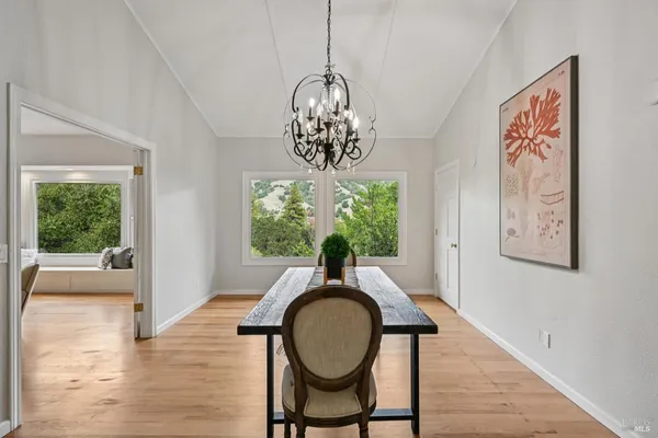 a view of a room with wooden floor and window