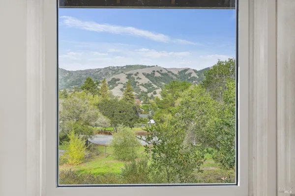 an empty room with wooden floor and a window