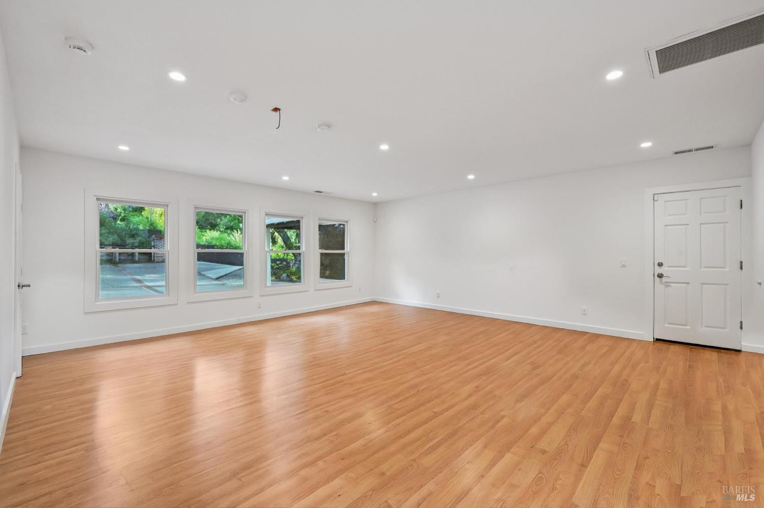 5 Maoli Drive San Rafael, CA 94903 - Photo 61 of 74 an empty room with wooden floor and windows