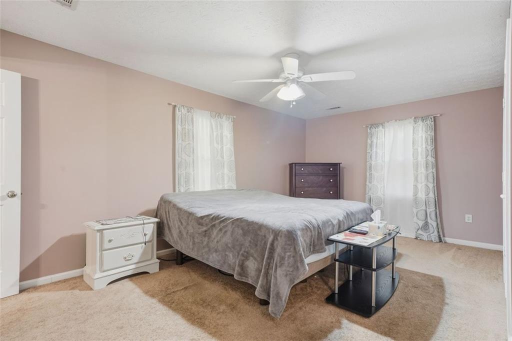 3170 Wages Circle Dacula, GA 30019 - Photo 16 of 39 a bedroom with a bed and a ceiling fan