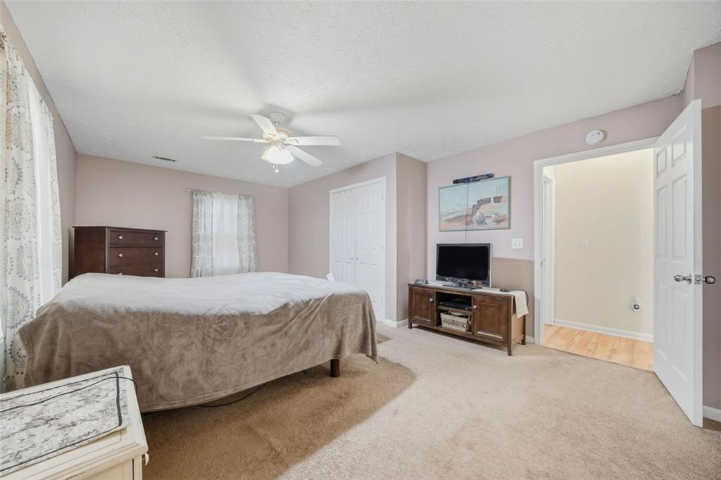 3170 Wages Circle Dacula, GA 30019 - Photo 17 of 39 a bedroom with a bed and a chandelier