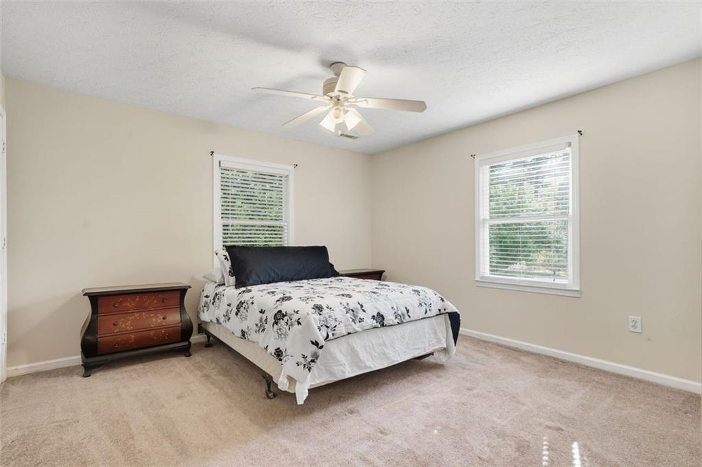 3170 Wages Circle Dacula, GA 30019 - Photo 23 of 39 a bedroom with a bed and a chandelier