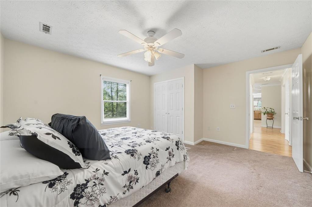 3170 Wages Circle Dacula, GA 30019 - Photo 24 of 39 a bedroom with a bed and a window