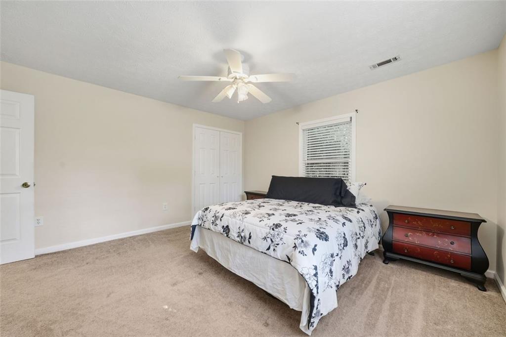 3170 Wages Circle Dacula, GA 30019 - Photo 25 of 39 a bedroom with a bed and a chandelier