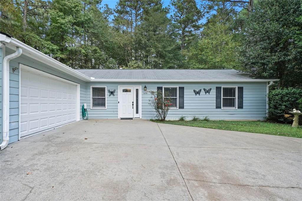 3170 Wages Circle Dacula, GA 30019 - Photo 27 of 39 a front view of a house with a yard and a garage