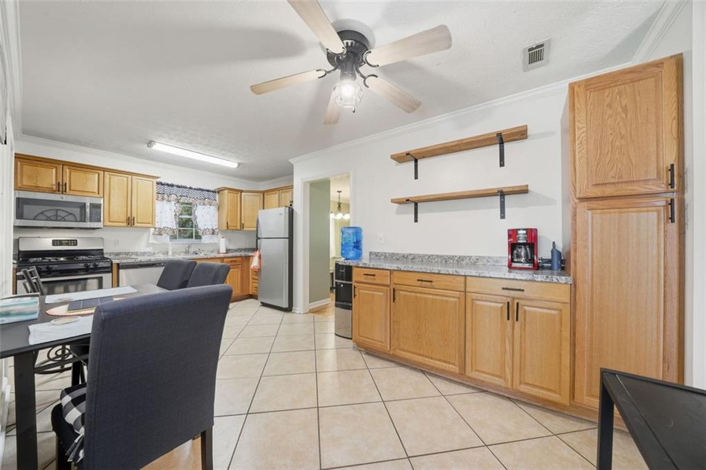 3170 Wages Circle Dacula, GA 30019 - Photo 3 of 39 a kitchen with stainless steel appliances granite countertop a refrigerator and a stove top oven