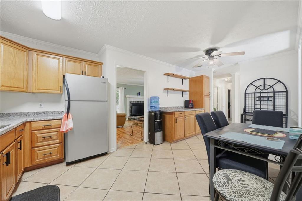 3170 Wages Circle Dacula, GA 30019 - Photo 7 of 39 a kitchen with stainless steel appliances granite countertop a refrigerator a stove a sink dishwasher and white cabinets with wooden floor