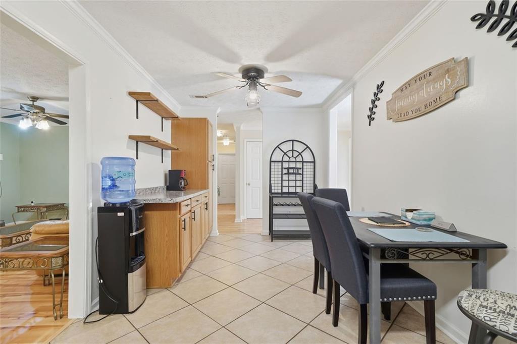 3170 Wages Circle Dacula, GA 30019 - Photo 8 of 39 a kitchen with stainless steel appliances granite countertop a dining table chairs and a refrigerator