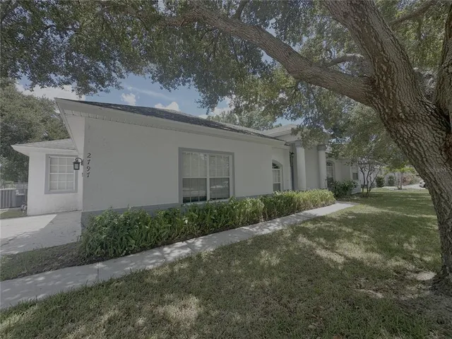 a view of a house with a yard and garage