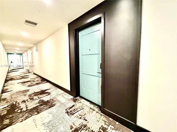 a view of an empty room with wooden walls