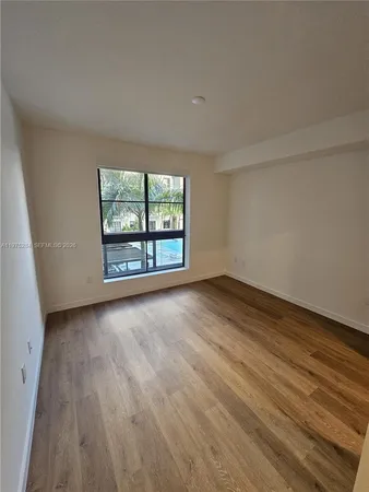 a kitchen with stainless steel appliances kitchen island sink refrigerator stove and wooden floor