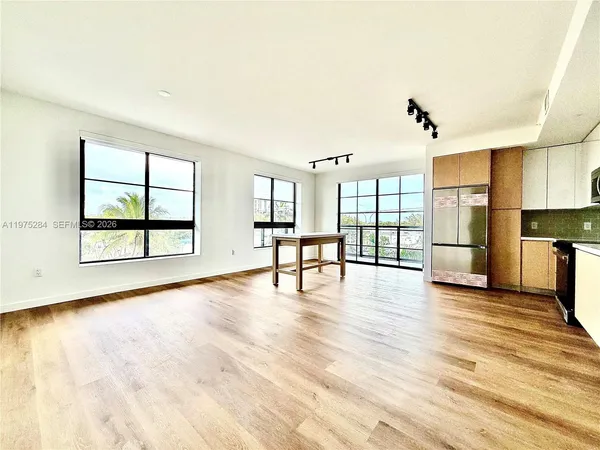a view of a kitchen with furniture and windows
