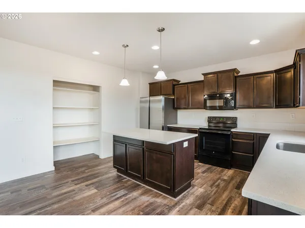 a view of kitchen with furniture and wooden floor