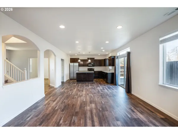 a view or kitchen with cabinets and wooden floor