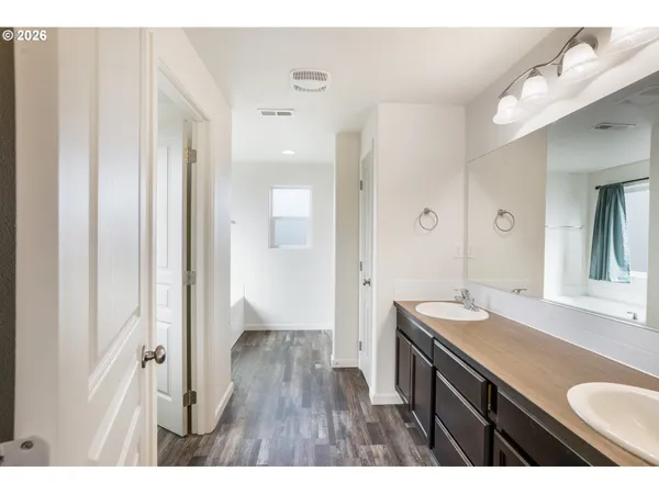 a bathroom with a bathtub and a window