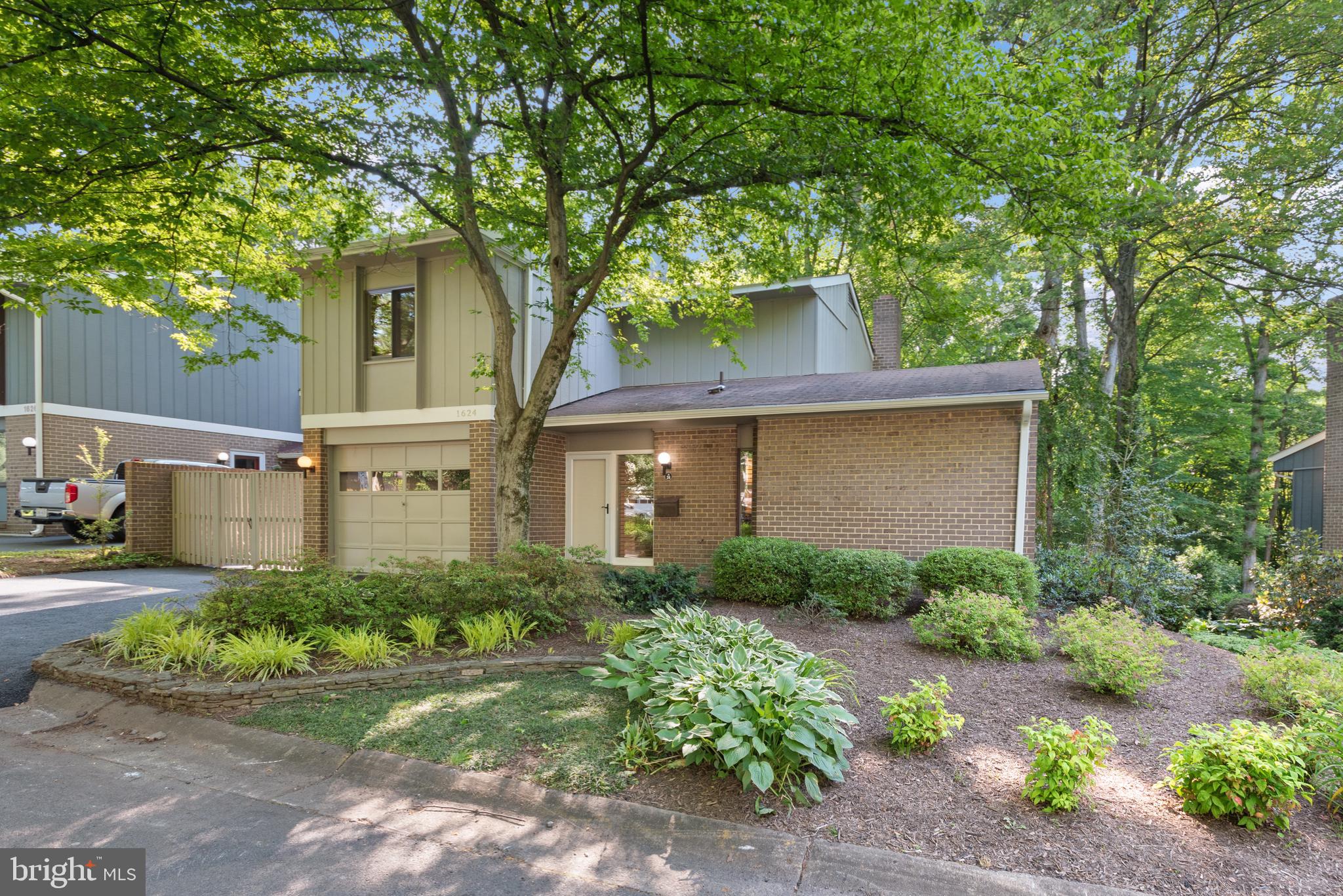 1624 Greenbriar Court Reston, VA 20190 - Photo 1 of 36 a front view of a house with a yard and potted plants