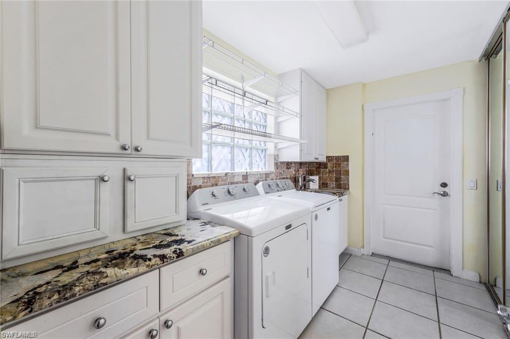 4823 Lasqueti Way Naples, FL 34119 - Photo 13 of 35 a kitchen with granite countertop a sink stove and cabinets
