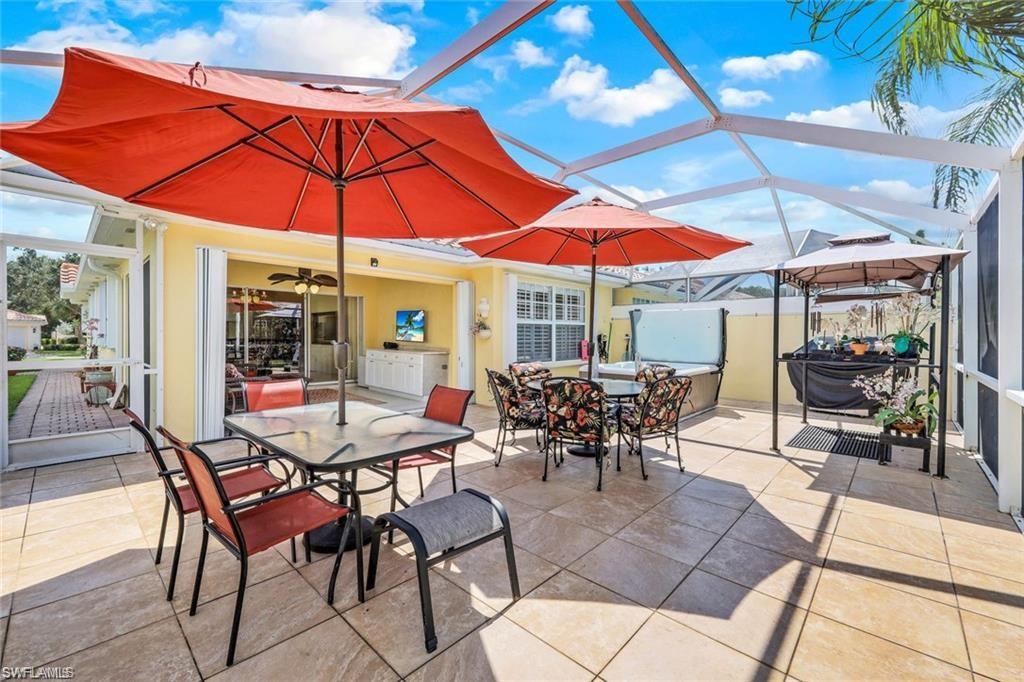 4823 Lasqueti Way Naples, FL 34119 - Photo 17 of 35 an outdoor space with furniture and umbrella