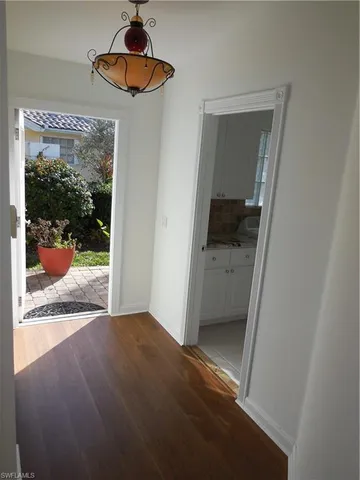 a dining room with furniture a rug and chandelier