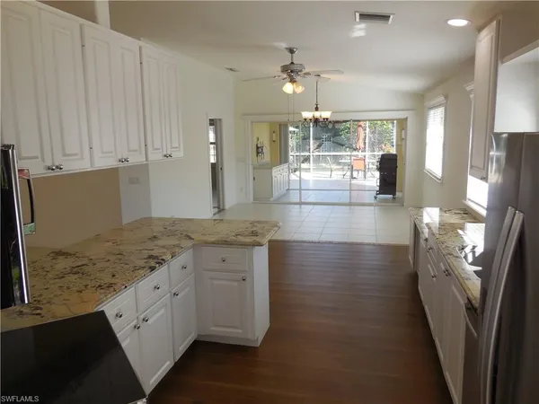 a view of a kitchen cabinets and chandelier