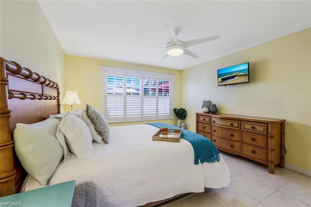 4823 Lasqueti Way Naples, FL 34119 - Photo 9 of 35 a bed room with a bed and a chair