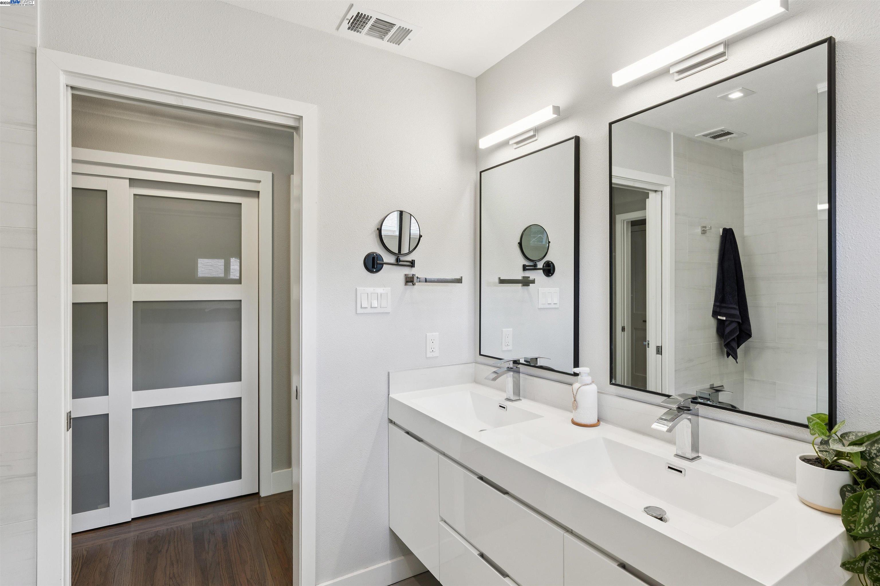 1230 Hale Drive Concord, CA 94518 - Photo 29 of 60 a bathroom with a double vanity sink and a mirror