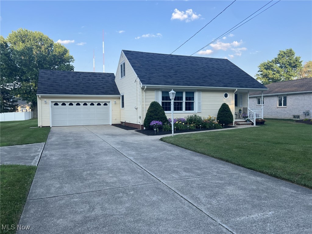 7579 McCreary Road Independence, OH 44131 - Photo 1 of 33 View of front of property featuring a front lawn, driveway, an attached garage, and a shingled roof