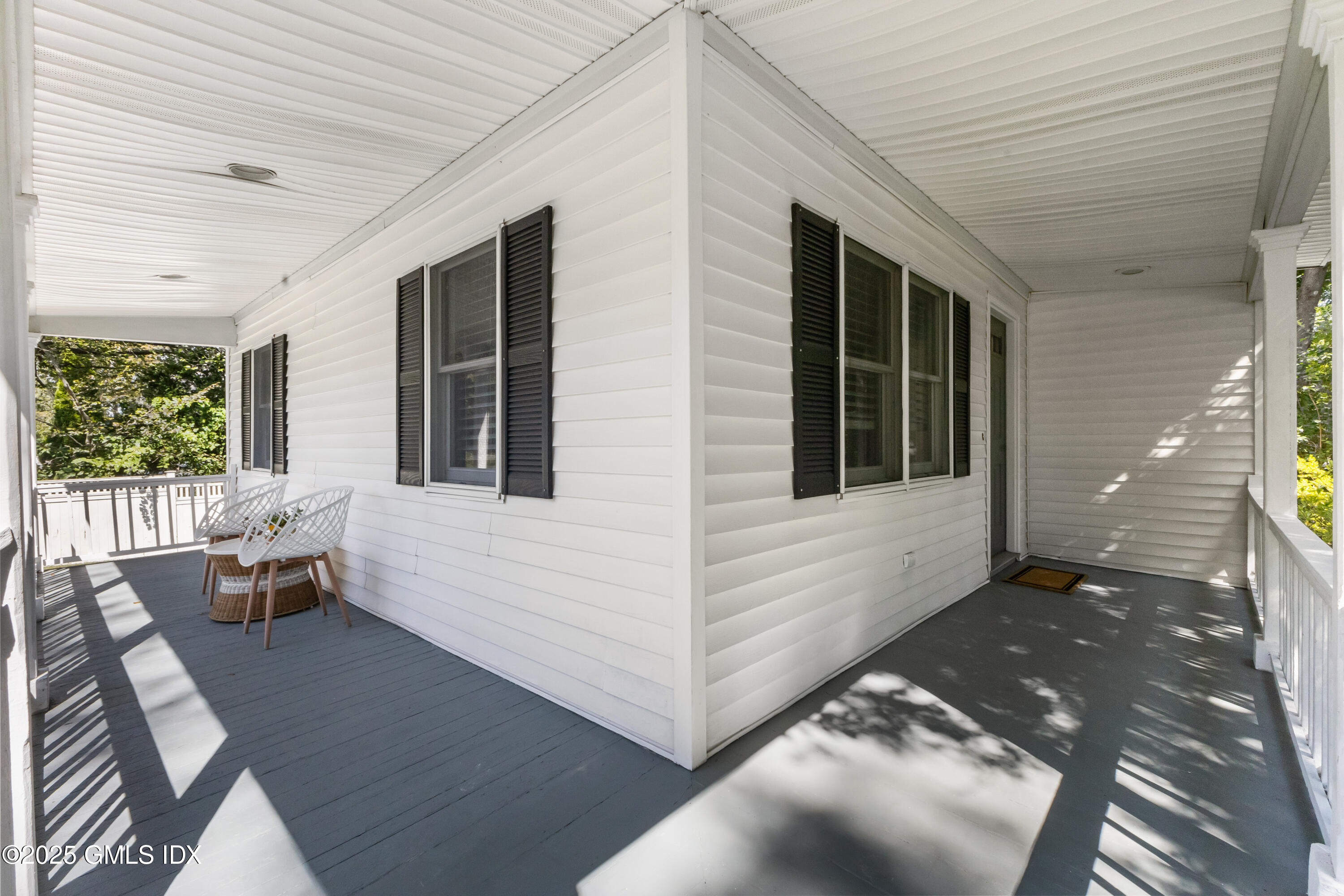 63 Riverside Avenue Riverside, CT 06878 - Photo 2 of 26 a view of a patio with table and chairs with wooden floor and fence