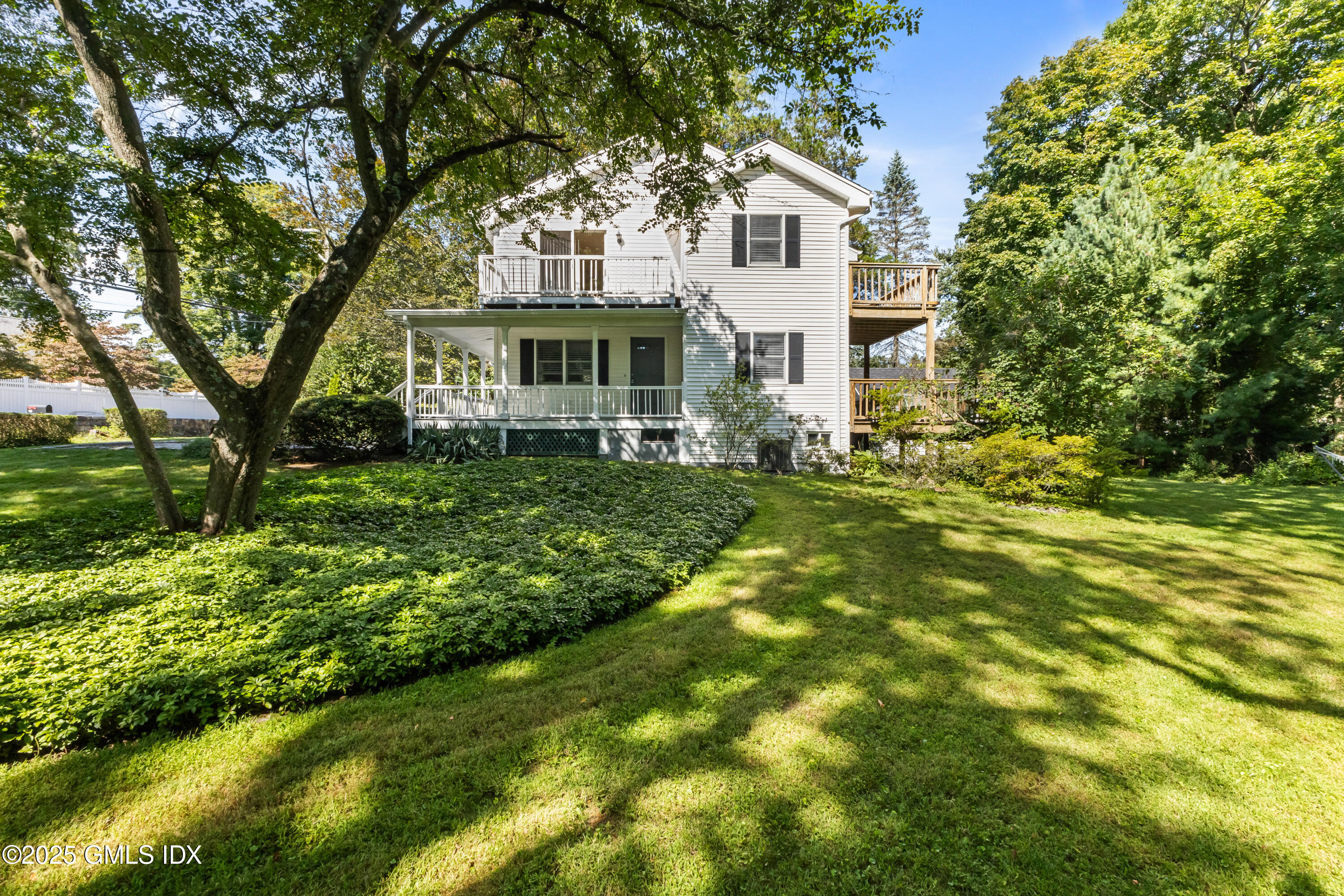 63 Riverside Avenue Riverside, CT 06878 - Photo 21 of 26 a front view of a house with a garden