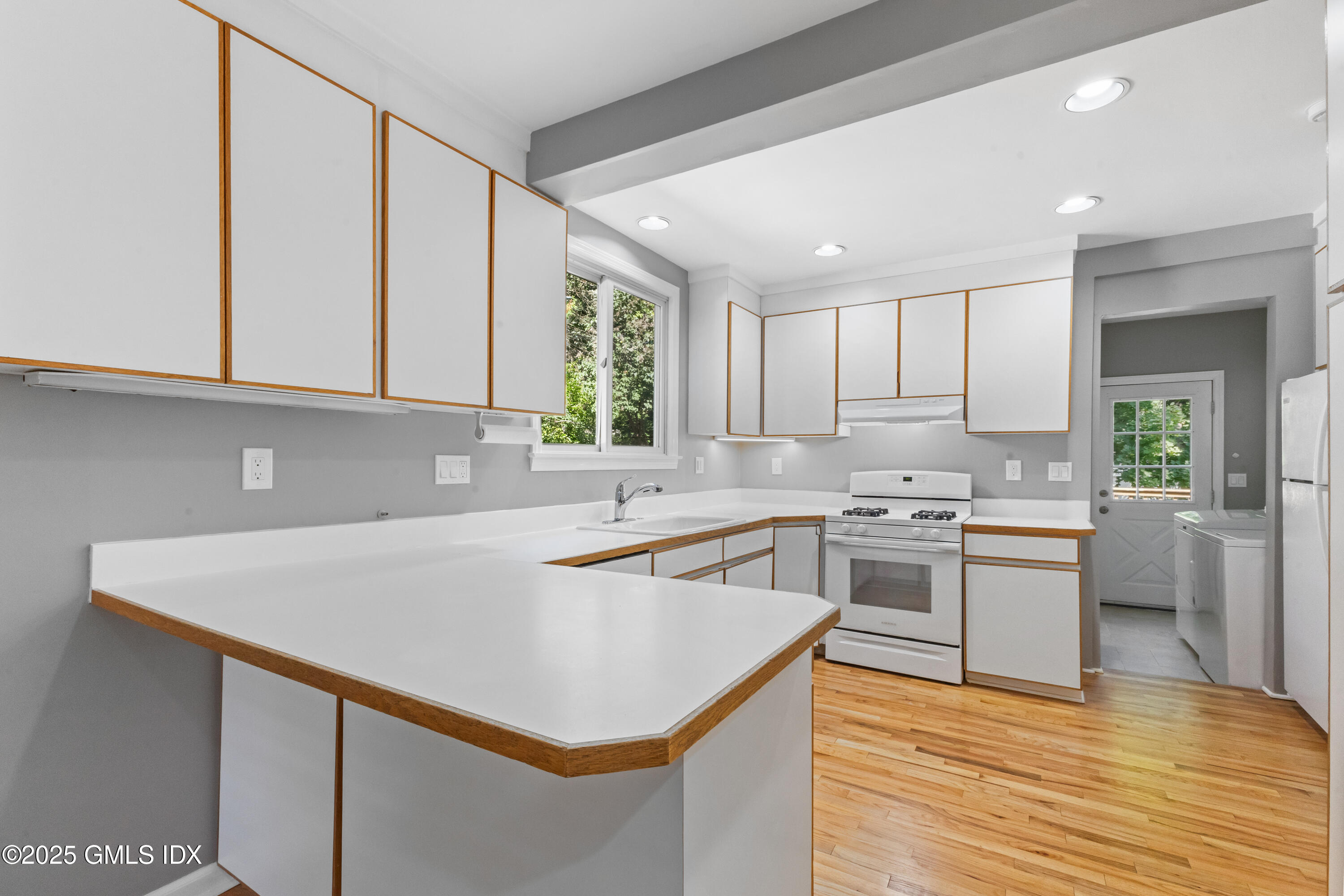 63 Riverside Avenue Riverside, CT 06878 - Photo 6 of 26 a kitchen with a sink a stove a refrigerator and a window