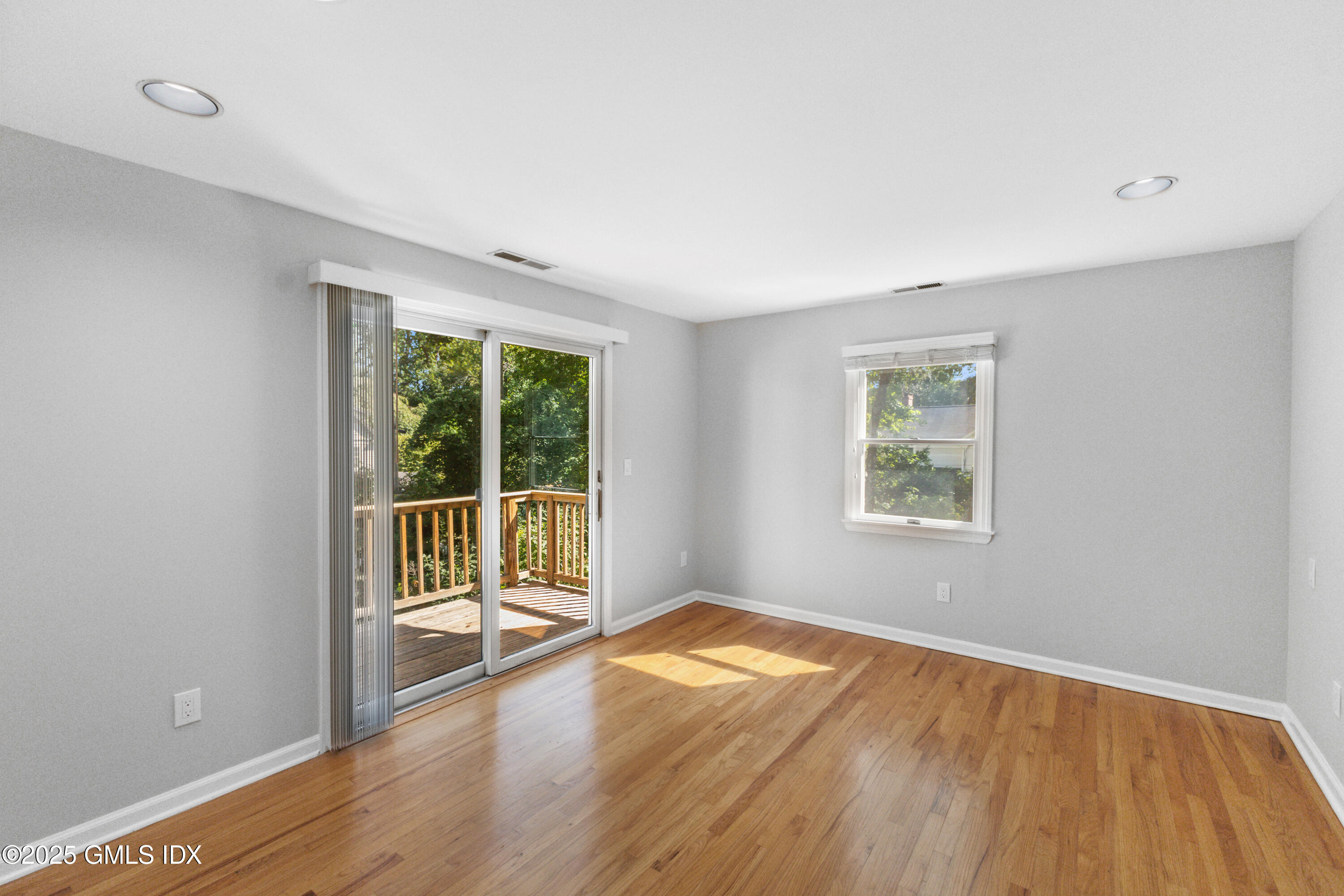 63 Riverside Avenue Riverside, CT 06878 - Photo 10 of 26 an empty room with wooden floor and windows