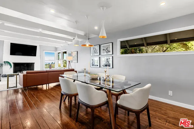 a kitchen with stainless steel appliances white cabinets and wooden floor