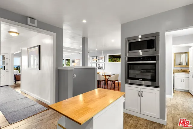 a bathroom with a granite countertop sink vanity and toilet