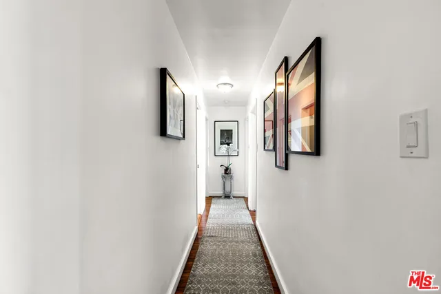 a bedroom with furniture and a flat screen tv